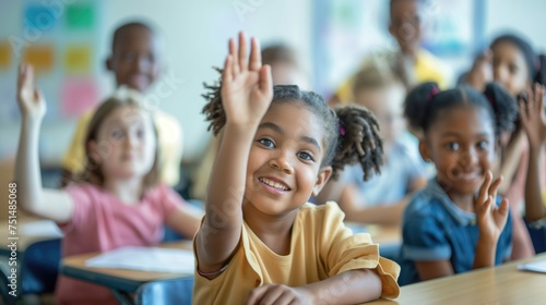 Primary school diverse cheerful smiling children sitting in light classroom with their hands up eager to answer the teacher's question