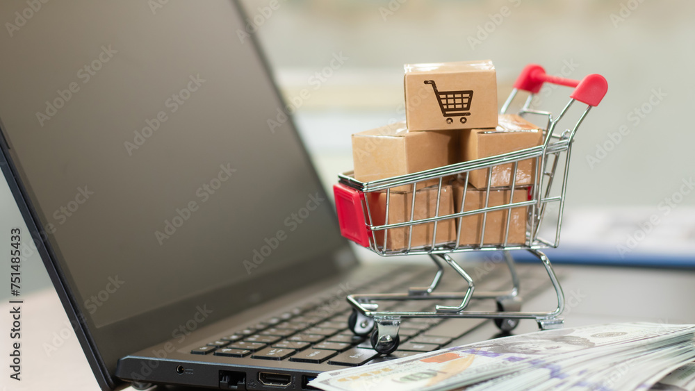 Boxes in a trolley on a laptop keyboard. Ideas about online shopping, online shopping is a form of electronic commerce that allows consumers to directly buy goods from a seller over the internet.