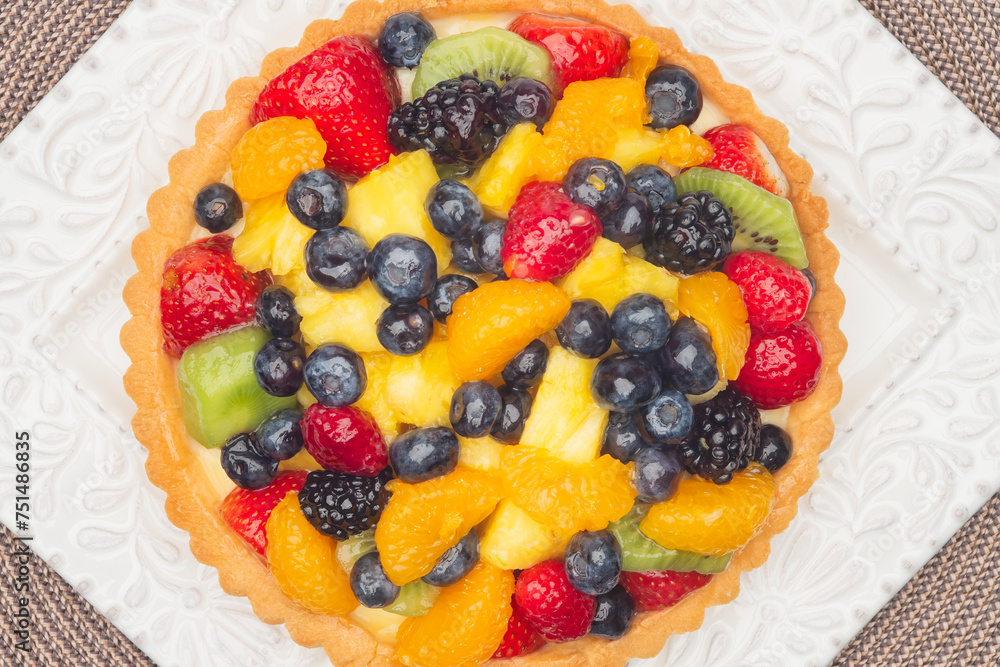 Looking straight down on a fruit tart with fresh fruit custard and crust