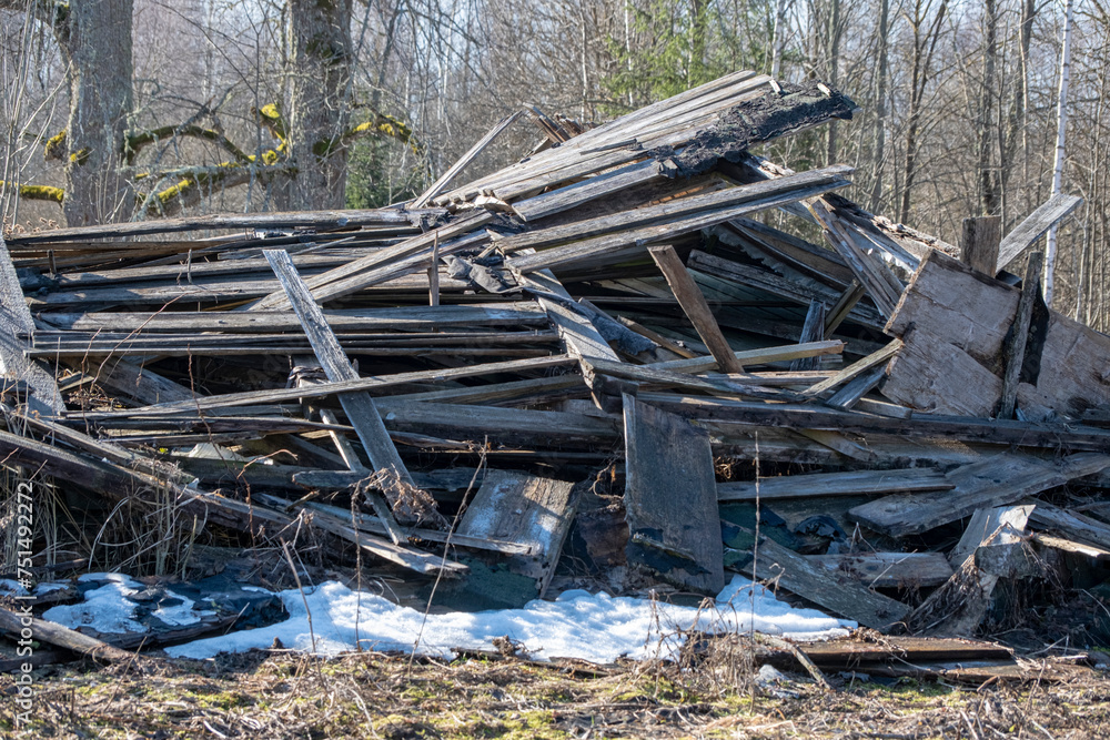 broken old wooden building in countryside. Pile of wooden planks broken old wooden building in countryside. Pile of wooden planks