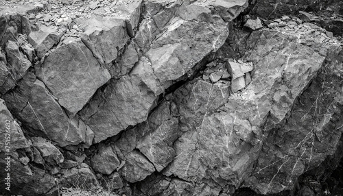 Black and white rock background symbolizing contrast and resilience. Distressed dark gray stone texture, close-up of mountain surface
