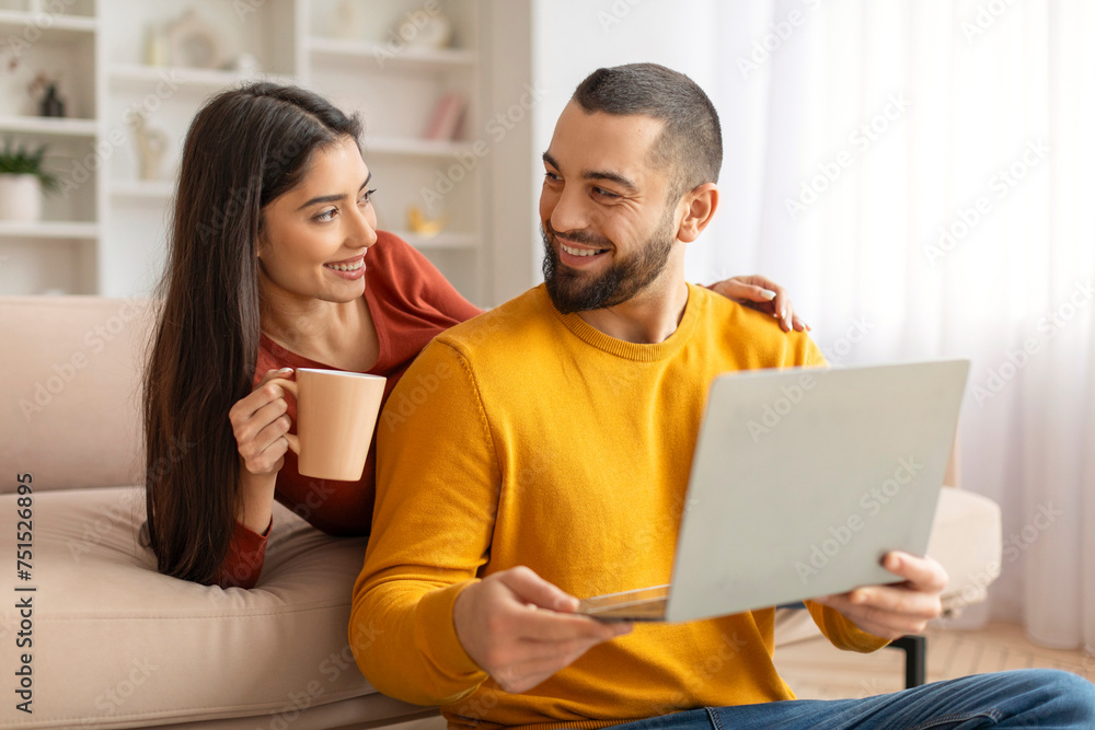 Weekend Pastime. Happy Couple Resting With Laptop And Coffee In Living Room Weekend Pastime. Happy Couple Resting With Laptop And Coffee In Living Room