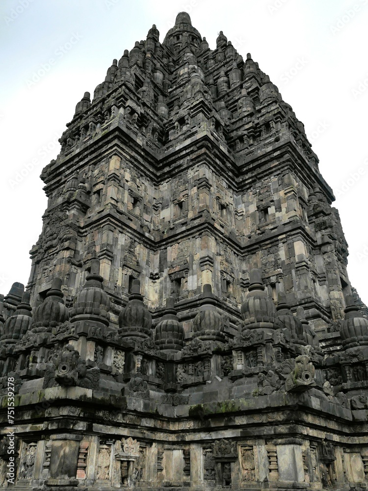 A Hindu temple in Indonesia, named Candi Prambanan, seen from a short distance in the daylight.