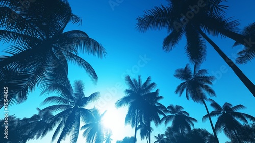 Palms swaying in the breeze  their silhouettes contrasting against the clear  deep blue sky of a tropical paradise.