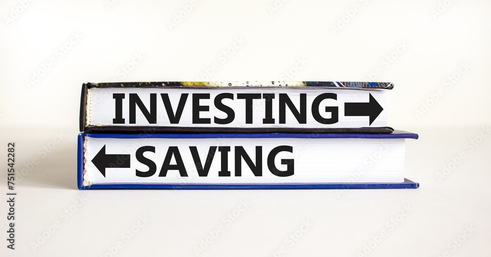 Saving or investing symbol. Concept word Saving or Investing on beautiful books. Beautiful white table white background. Business and saving or investing concept. Copy space.
