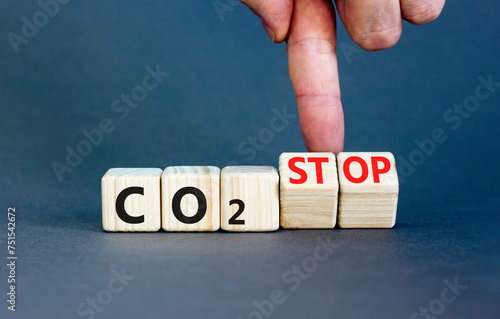 CO2 stop symbol. Concept word CO2 or CO2 stop on a beautiful wooden cubes. Beautiful grey table grey background. Businessman hand. Business ecological and CO2 stop concept. Copy space.