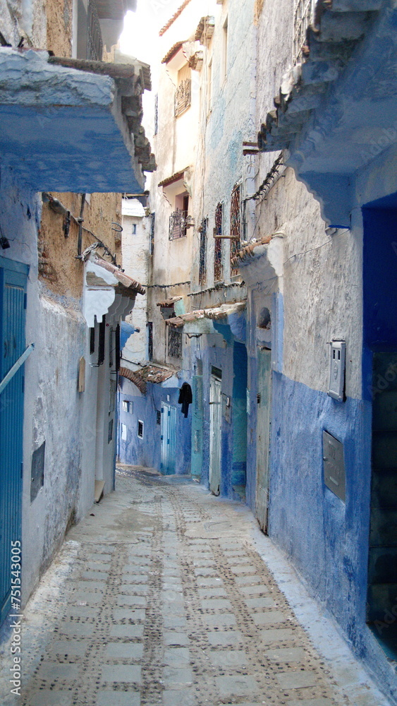 Alley between blue and white buildings in the medina in Chefchaouen, Morocco