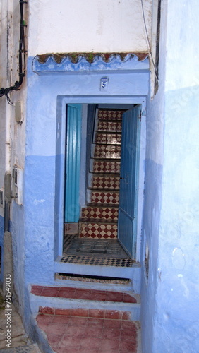 Tiled stairs inside a doorway in the medina, in Chefchaouen, Morocco © Angela