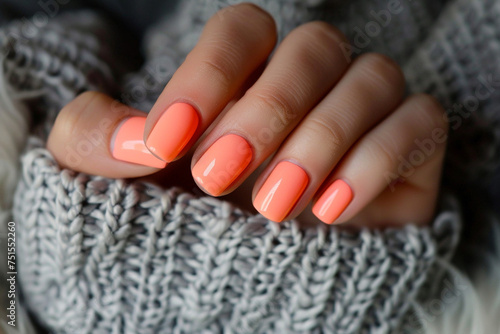 Female hand with orange nail design. Glitter pink nail polish manicure.