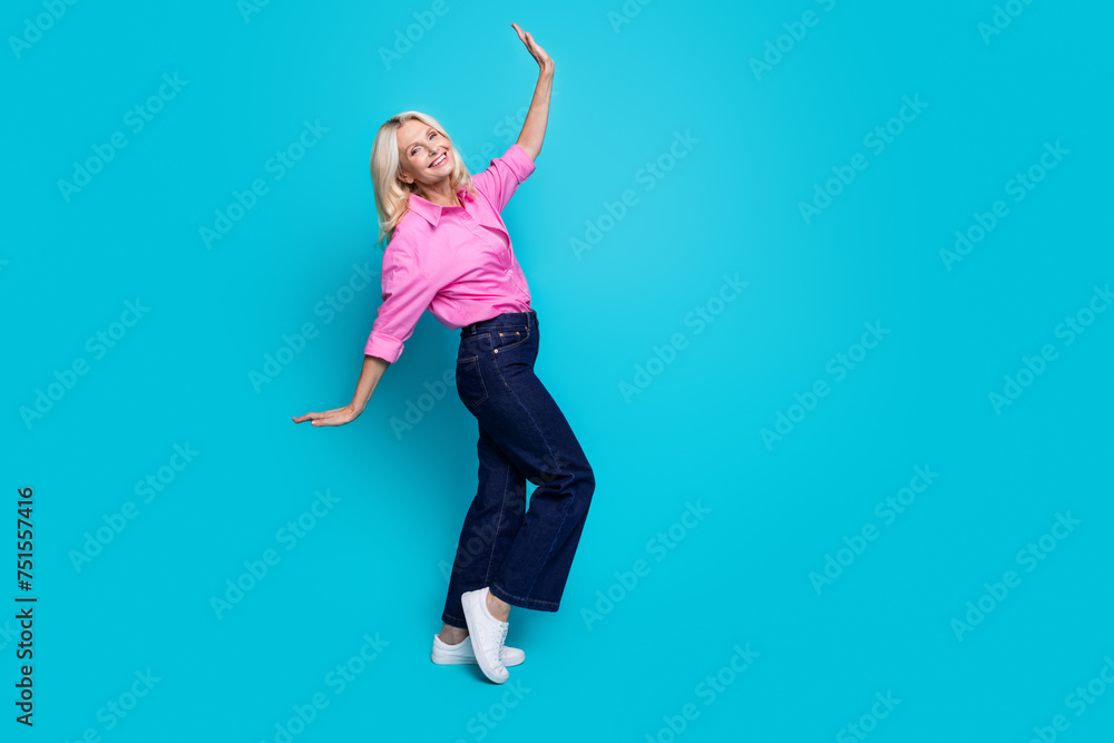 Fototapeta premium Full body photo of attractive retired woman cool dancing dressed stylish pink smart casual clothes isolated on aquamarine color background