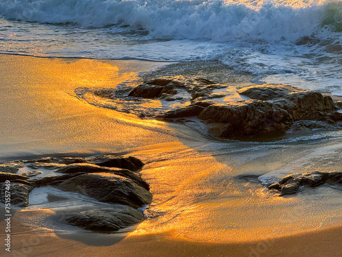 Golden Shores: Sunset's Embrace on Coastal Rocks