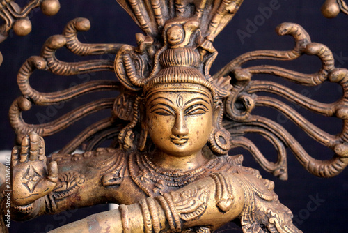   Bronze deity of dancing Shiva close-up.  Portrait of a Hindu God.