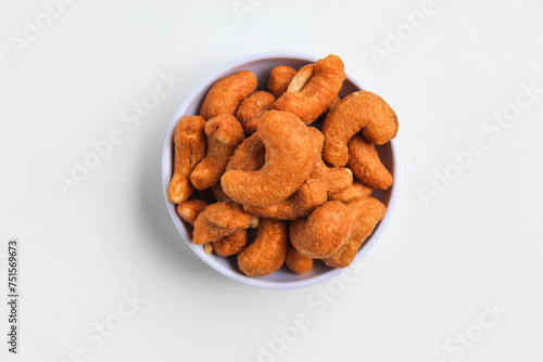 Cashew nut in a white small bowl. isolated on white background, flat lay or top view