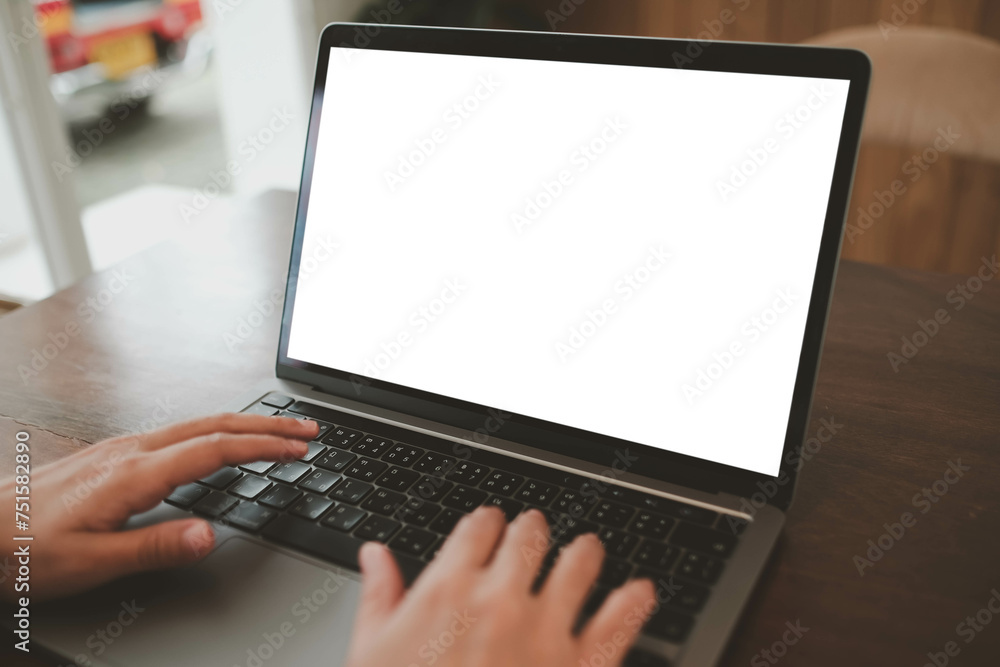 Close-up image of a man sitting in the cafe and using his laptop. laptop white blank screen mockup for display your graphic banner... Close-up image of a man sitting in the cafe and using his laptop. laptop white blank screen mockup for display your graphic banner...