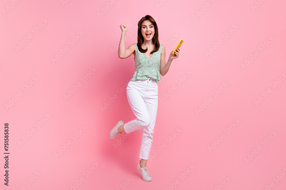 Full length photo of overjoyed glad girl rejoice free wifi speed 5g connection isolated on pink color background Full length photo of overjoyed glad girl rejoice free wifi speed 5g connection isolated on pink color background