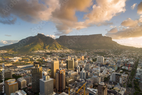 An aerial view of Cape Town central business district in late afternoon as the sun is setting, showing Table Mountain. photo