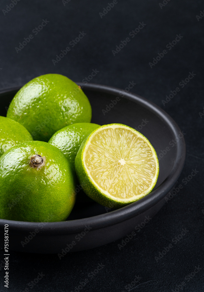 Lime fruit in black bowl closeup Lime fruit in black bowl closeup
