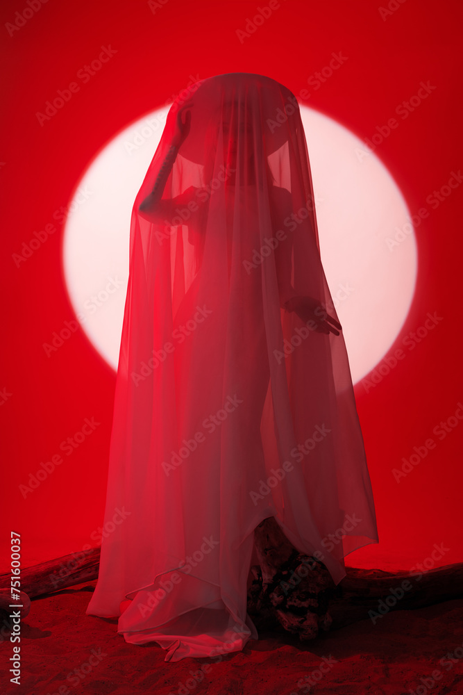 Ideal bride in wedding dress posing in studio with set design of desert sunset