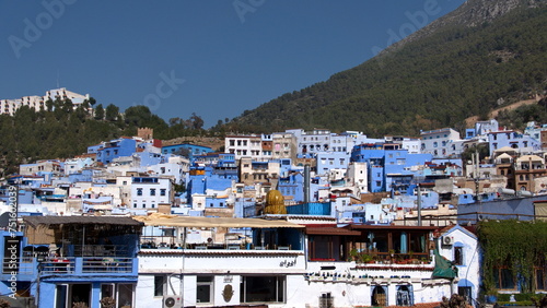 Blue and white buildings in the medina, on the side of a hill, in Chefchaouen, Morocco © Angela