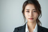 Experience the realism of a beautiful Asian businesswoman portrayed against a pure white background, with meticulous clarity and sharpness, tailored for an impactful business banner design
