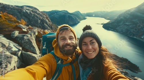 Couple tourist selfie in Norway hiking area - mountain trail above town of Skodje (Sunnmore region). Outdoor recreation activity.