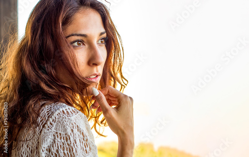 Mujer joven española en actitud pensativa mirando el horizonte con un fondo aislado blanco photo