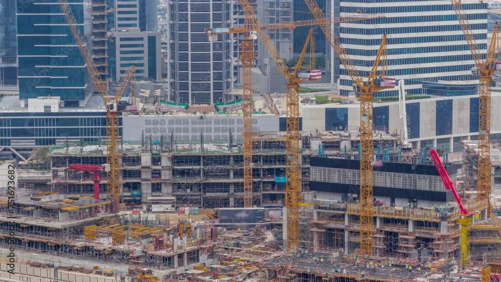 Large construction site with many working cranes timelapse during many hours. Top aerial view of big development of residential and office district in Business bay, Dubai Large construction site with many working cranes timelapse during many hours. Top aerial view of big development of residential and office district in Business bay, Dubai