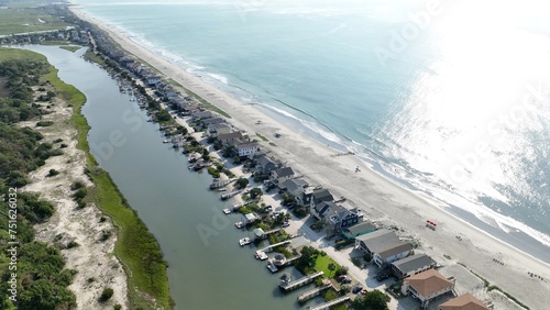 Vacation beach houses by the sea on the coast of South Carolina at Pawleys Island in early morning sunlight on a warm summer day  photo