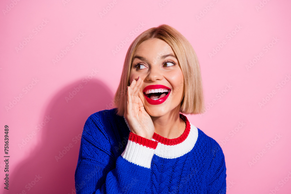 Closeup portrait of adorable young girl in blue knitted sweater touch cheek looking empty space gossips isolated on pink color background Closeup portrait of adorable young girl in blue knitted sweater touch cheek looking empty space gossips isolated on pink color background