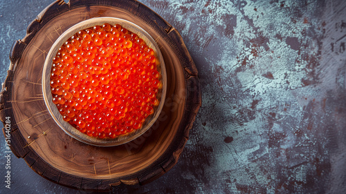 Red caviar on a decorated wooden board.