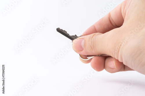 Hand a man holding a home key, isolated on white background