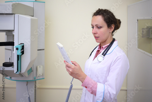 Medical worker uses orthopantomograph in the examination of the patient photo