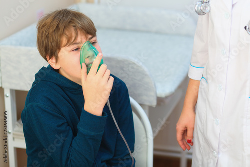 Young boy and nurse making inhalation with nebuliser in exam room