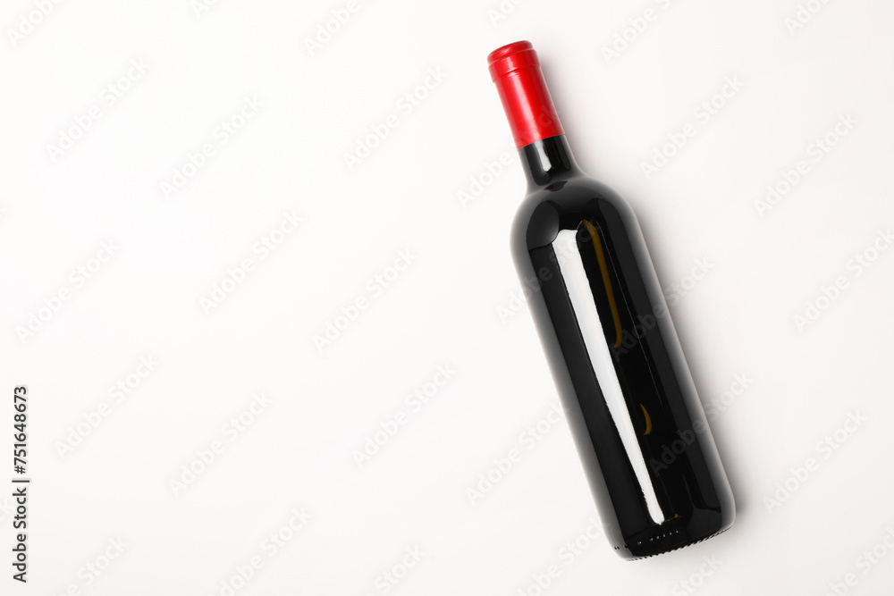 Bottle of expensive red wine on white background, top view. Space for text Bottle of expensive red wine on white background, top view. Space for text