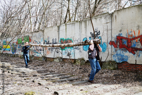  People carry tree trunk during cleaning works at Elk Island residential complex. More than 2.5 million people participate in annual voluntary Saturday work in Moscow.