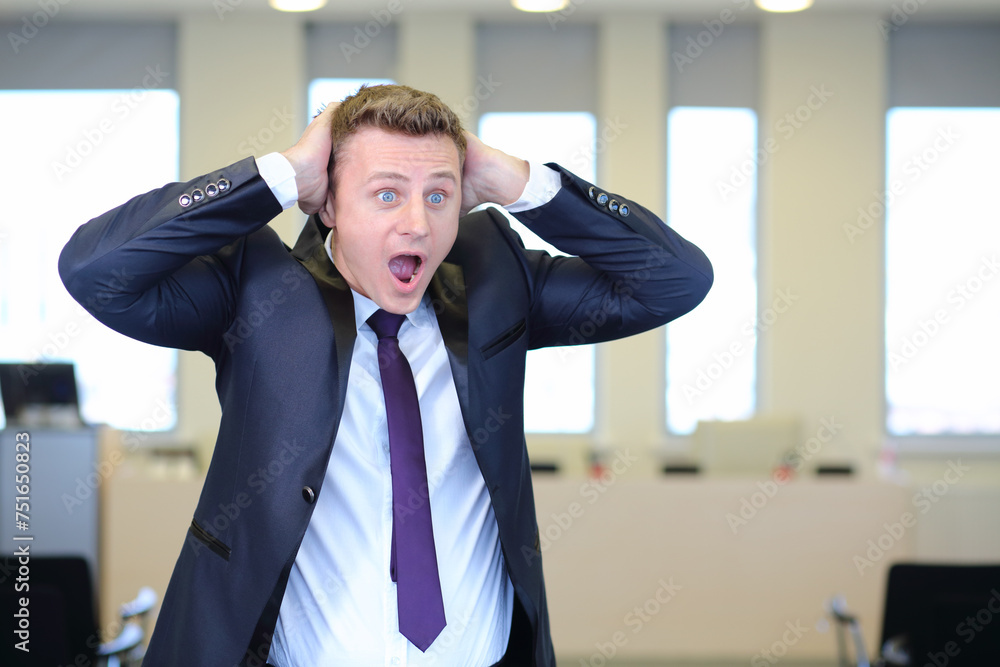 Very frightened businessman clutched his head in office Very frightened businessman clutched his head in office