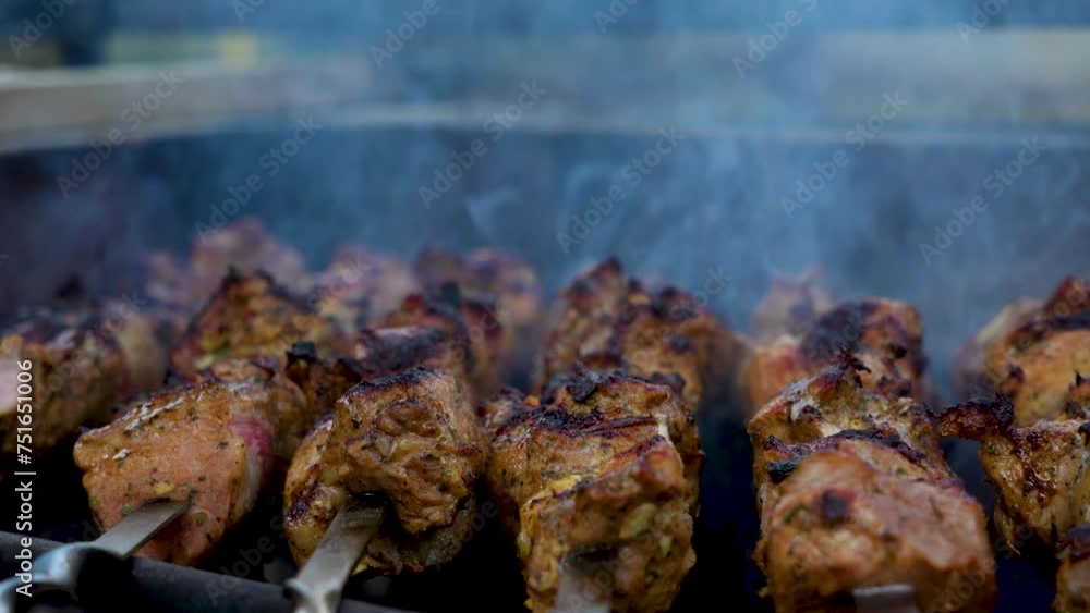 Cooked kebab of meat on skewers, Grilled kebab cooking on metal skewer, close up Cooked kebab of meat on skewers, Grilled kebab cooking on metal skewer, close up