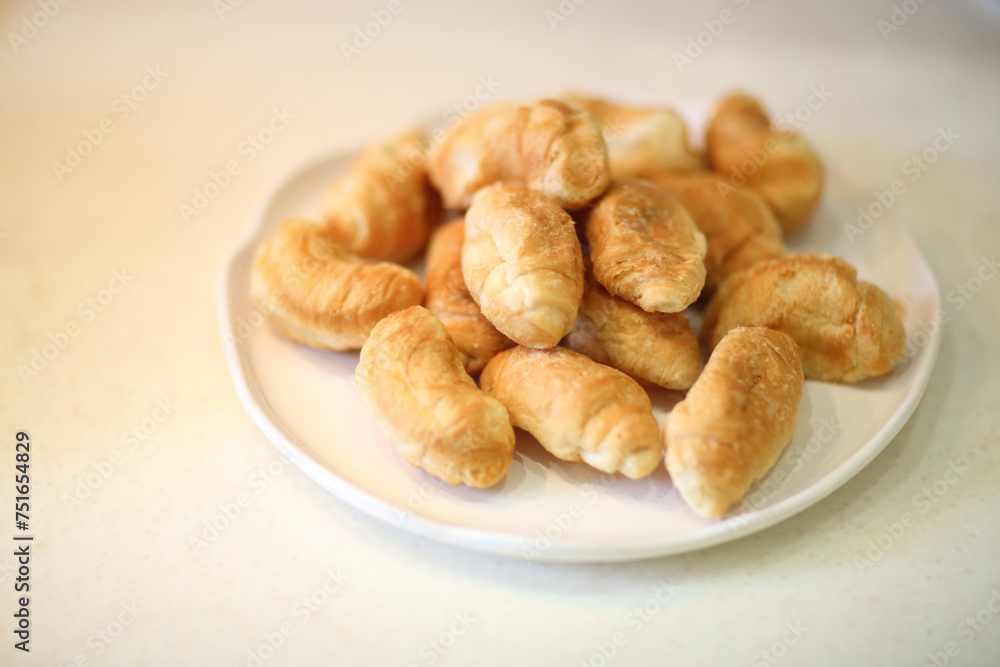 Pile of fresh and delicious mini croissants on a plate