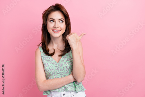Photo of cheerful lovely girl wear trendy spring clothes look empty space recommend cool product isolated on vivid pink color background © deagreez