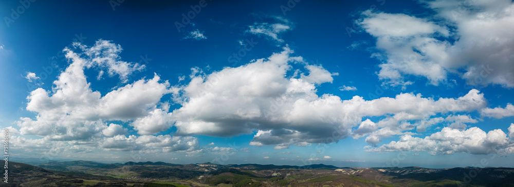 Big white fluffy clouds in the blue sky.Summer background. - Image	
