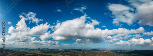 Big white fluffy clouds in the blue sky.Summer background. - Image 