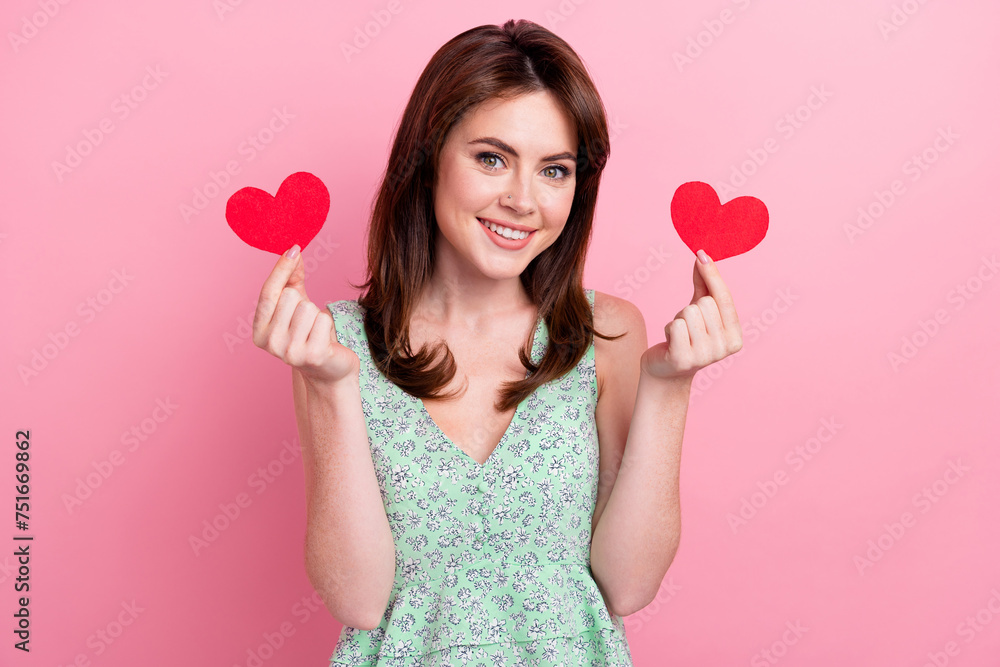 Photo of gorgeous lovely girl wear printed clothes showing red paper cards velentine day celebration isolated on pink color background Photo of gorgeous lovely girl wear printed clothes showing red paper cards velentine day celebration isolated on pink color background
