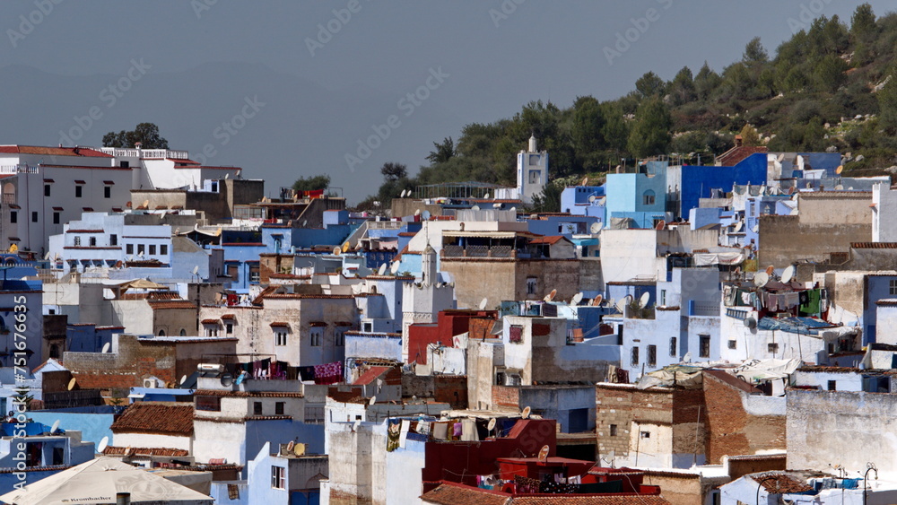 Blue and white buildings in the medina, on the side of a hill, in Chefchaouen, Morocco