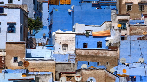 Blue and white buildings on a slope in the medina, in Chefchaouen, Morocco © Angela