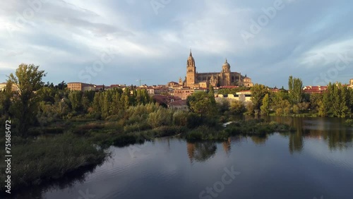 View of the Salamanca cathedral reflected in the Tormes river in Spain.