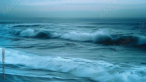Misty ocean waves under a muted sky. Seamless transition of sea to sky at the horizon. The ethereal beauty of a calm sea at dusk.