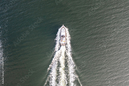 Fishing boat at sea full speed from above