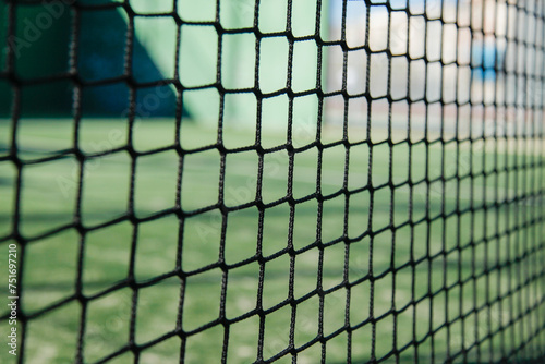 close up of the padel or tennis court net with green background