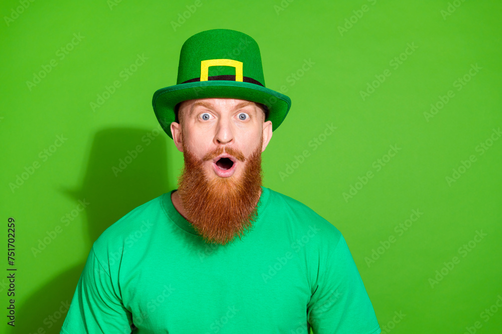 Photo of impressed speechless person open mouth cant believe empty space ad isolated on green color background Photo of impressed speechless person open mouth cant believe empty space ad isolated on green color background