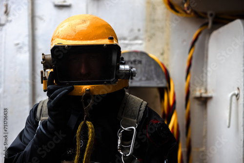 An industrial diver closeup in commercial diving helmet